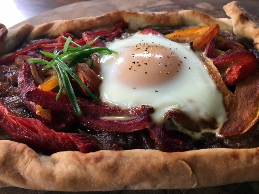 A flatbread finished with a farm egg from a Chicago private chef’s menu
