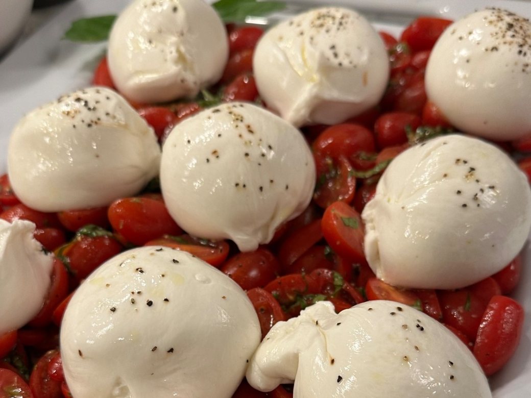 Burrata with cherry tomatoes laid out on a platter for a private dinner in Chicago